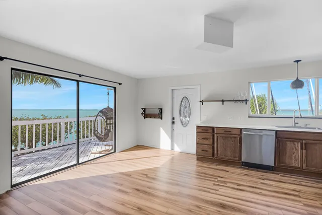 a view of a kitchen with a sink and wooden floor