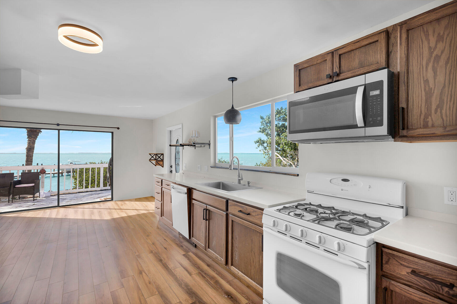 100 Point Pleasant Drive Key Largo, FL 33037 - Photo 16 of 32 a kitchen with stainless steel appliances granite countertop a stove a sink and a microwave