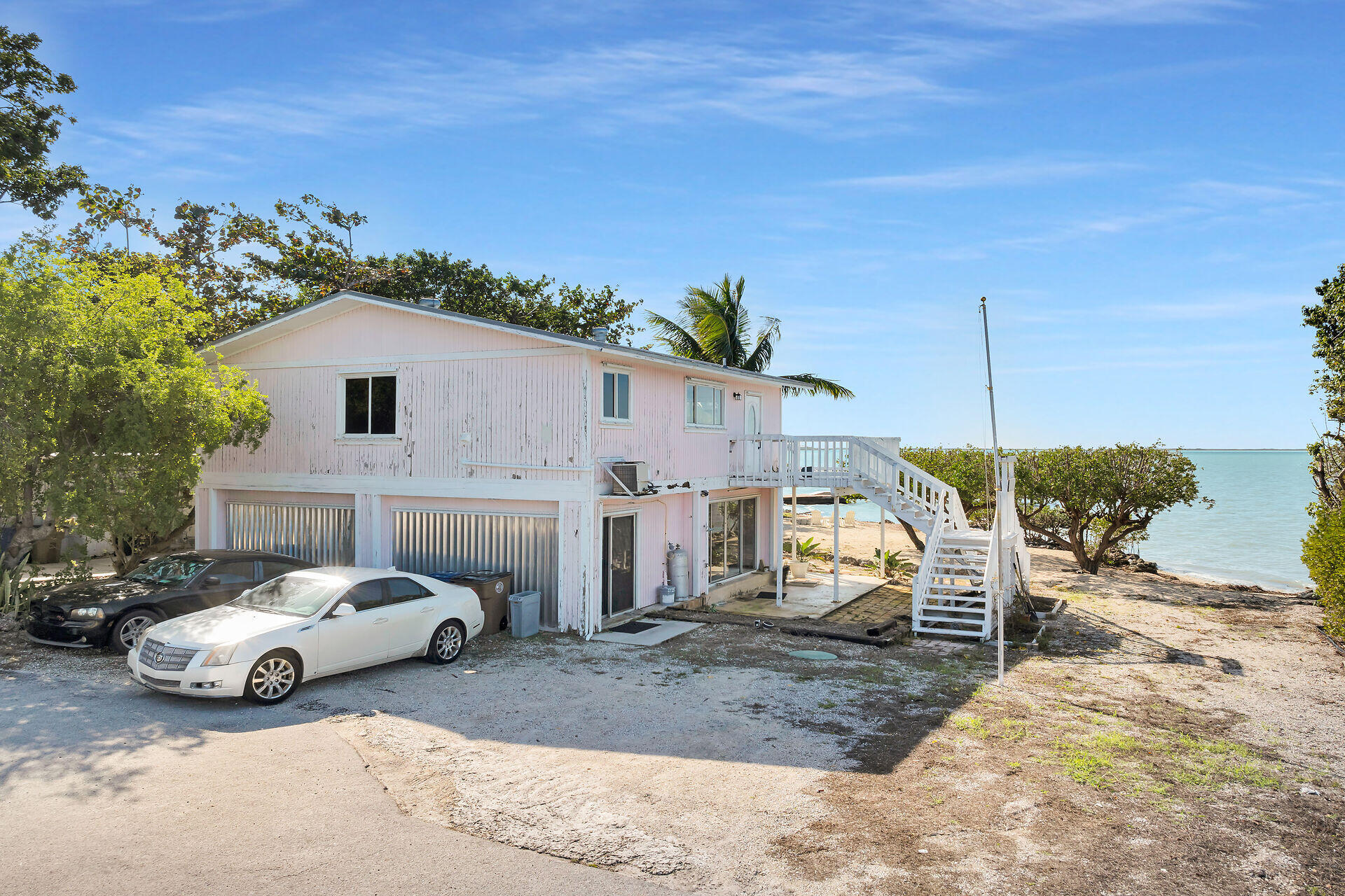 100 Point Pleasant Drive Key Largo, FL 33037 - Photo 2 of 32 a view of a car park in front of house