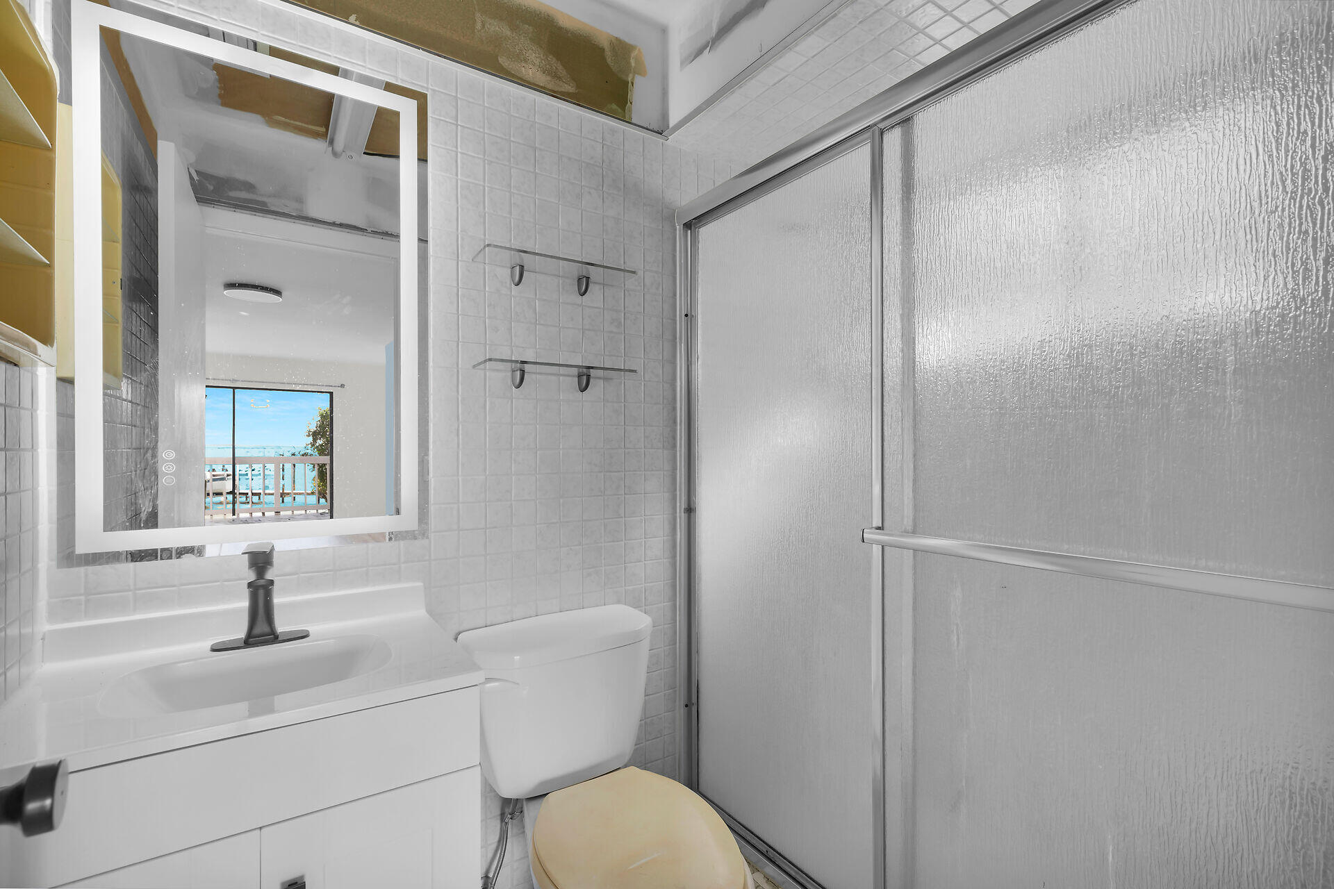 100 Point Pleasant Drive Key Largo, FL 33037 - Photo 23 of 32 a bathroom with a granite countertop sink toilet and shower