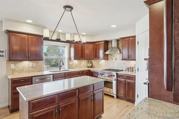 a kitchen with a sink stove and cabinets