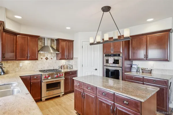 a kitchen with stainless steel appliances a sink and a stove top oven