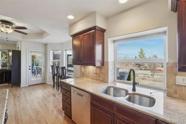 a kitchen with a sink cabinets and wooden floor