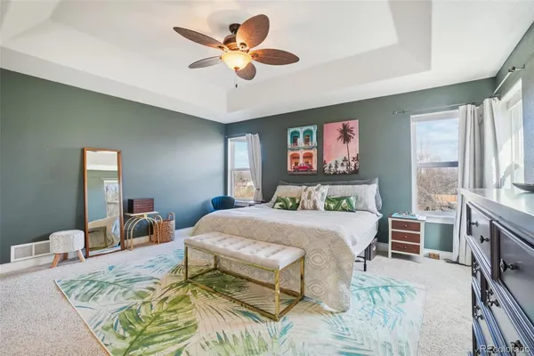 a large bedroom with a bed and a chandelier