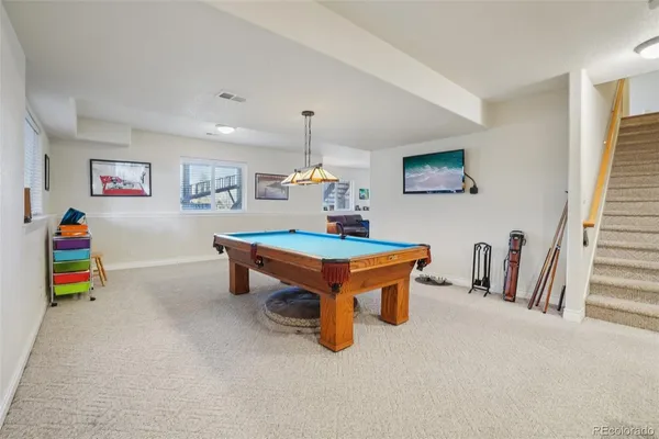 a room with furniture and air hockey table