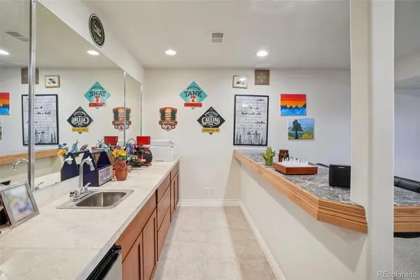 a kitchen filled a refrigerator a sink and wooden floor