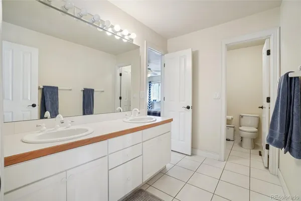 a spacious bathroom with a double vanity sink mirror and toilet