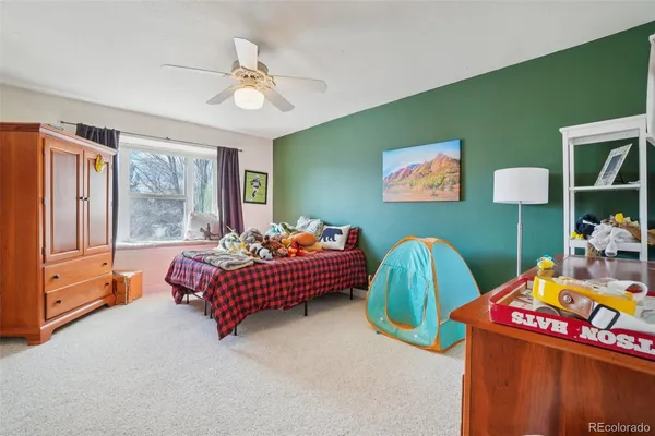 a bedroom with two beds and a chandelier