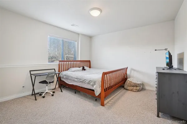 a bedroom with a bed and chair