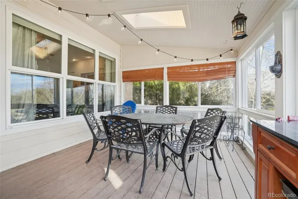 a view of a dining room with furniture large windows and wooden floor