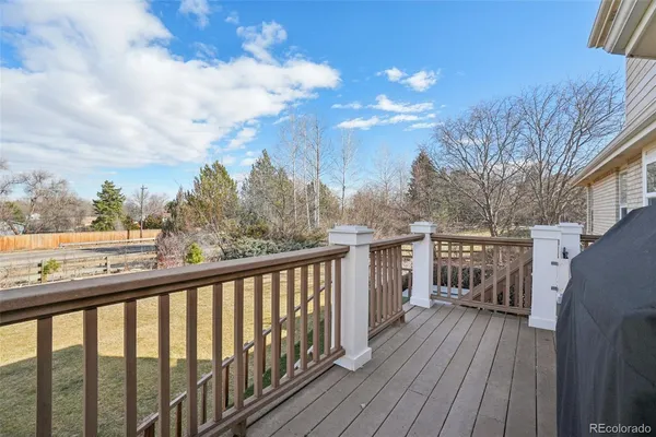a balcony with wooden floor and city view