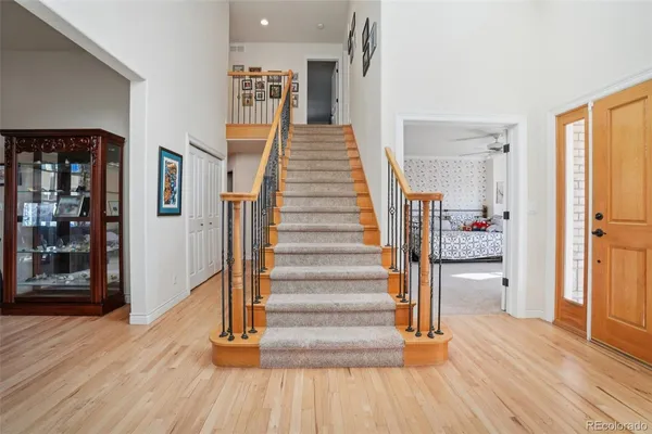 a view of entryway with wooden floor and stairs
