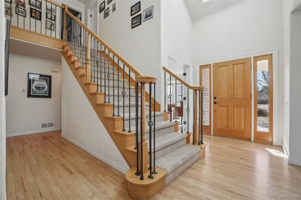 a view of an entryway with wooden floor