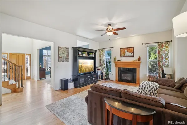 a living room with furniture a flat screen tv and a fireplace