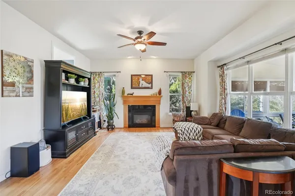 a living room with furniture a flat screen tv and a fireplace