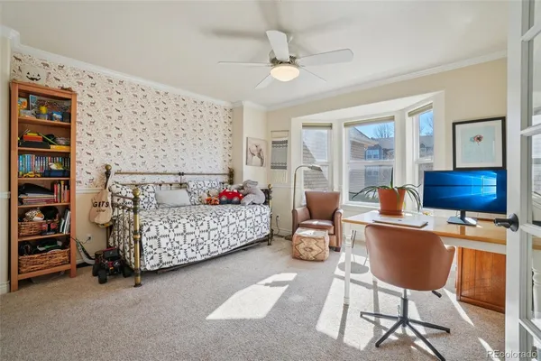 a bed room with a bed and a chair