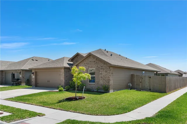 a aerial view of a house with a yard and porch