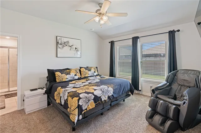 a bed sitting in a bedroom next to a window