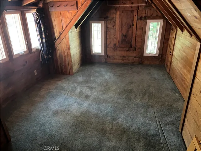 a bedroom with a bed and windows