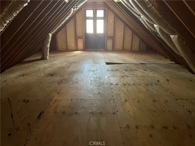 a room with wooden floor and windows