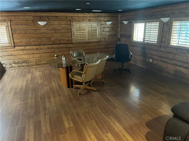 a room with wooden floor and furniture