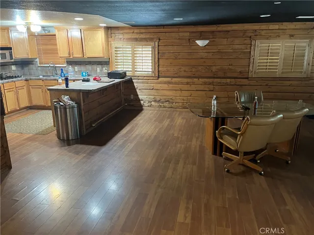 a kitchen with sink cabinets and wooden floor
