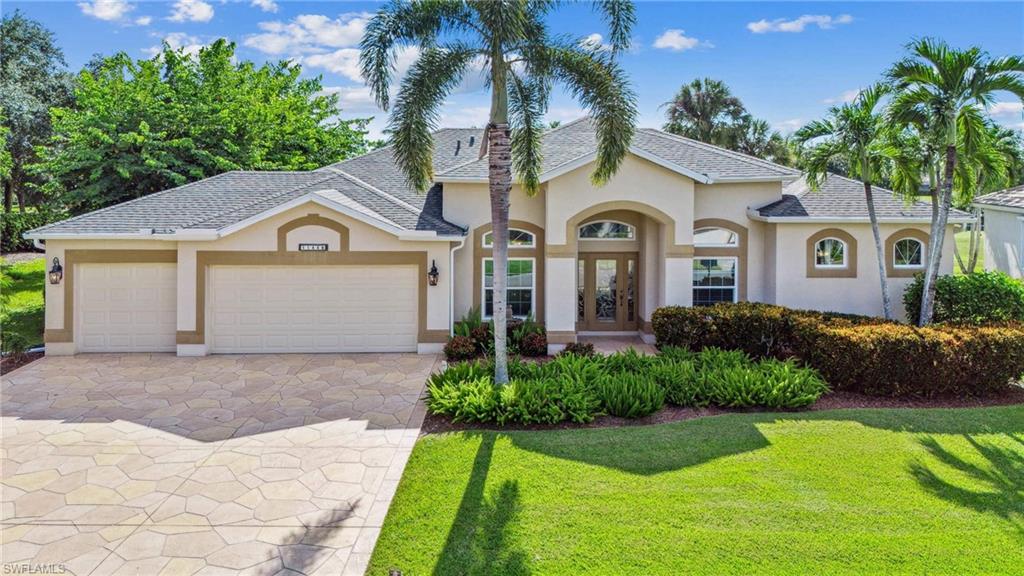 11446 Stratham Loop Estero, FL 33928 - Photo 1 of 27 a front view of a house with a garden