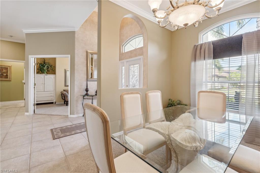 11446 Stratham Loop Estero, FL 33928 - Photo 13 of 27 a living room with furniture a chandelier and a table