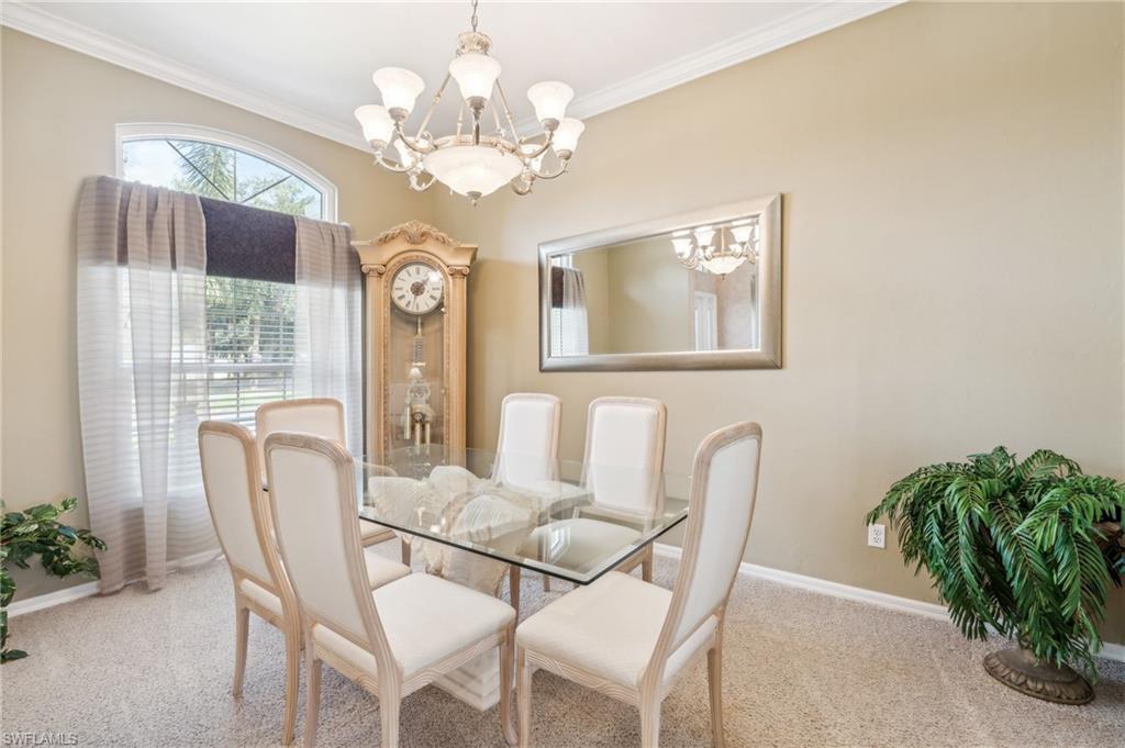 11446 Stratham Loop Estero, FL 33928 - Photo 14 of 27 a dining room with furniture and chandelier