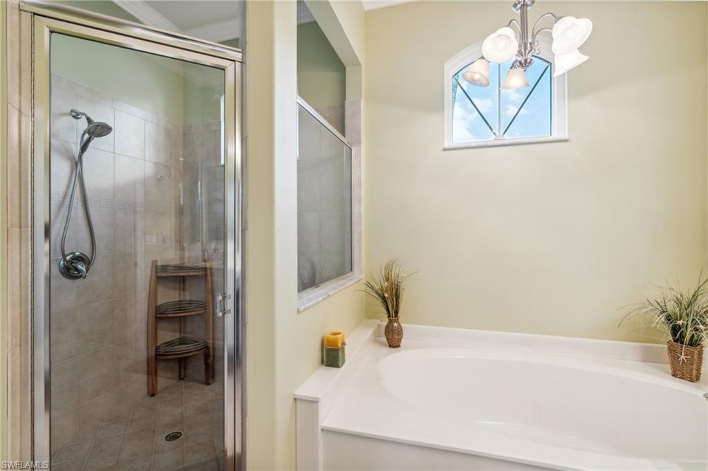 11446 Stratham Loop Estero, FL 33928 - Photo 18 of 27 a bathroom with a bathtub and a shower