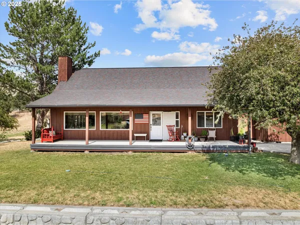 a front view of house with yard and outdoor seating