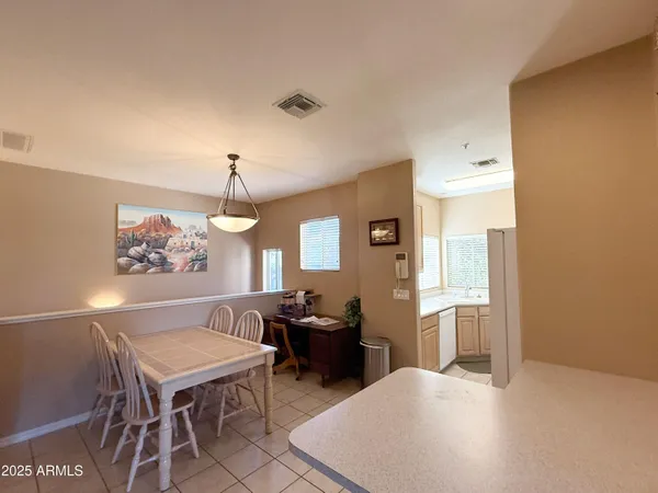 a living room with furniture a dining table and a window