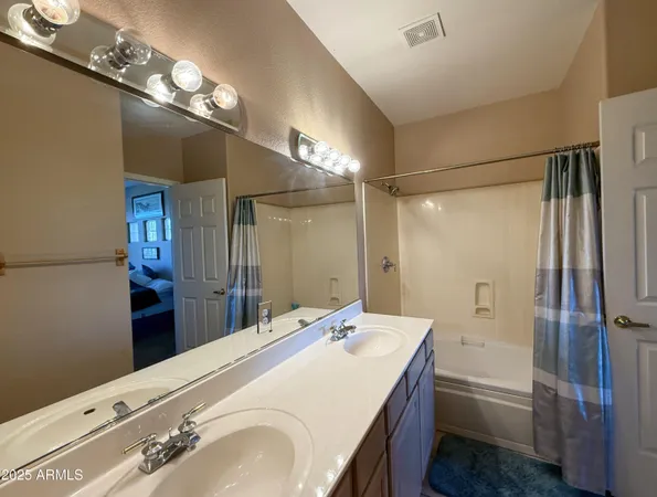 a spacious bathroom with a bathtub shower sink and a mirror
