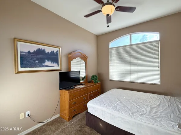 a bedroom with a bed dresser and a window