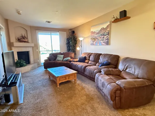 a living room with furniture and a fireplace