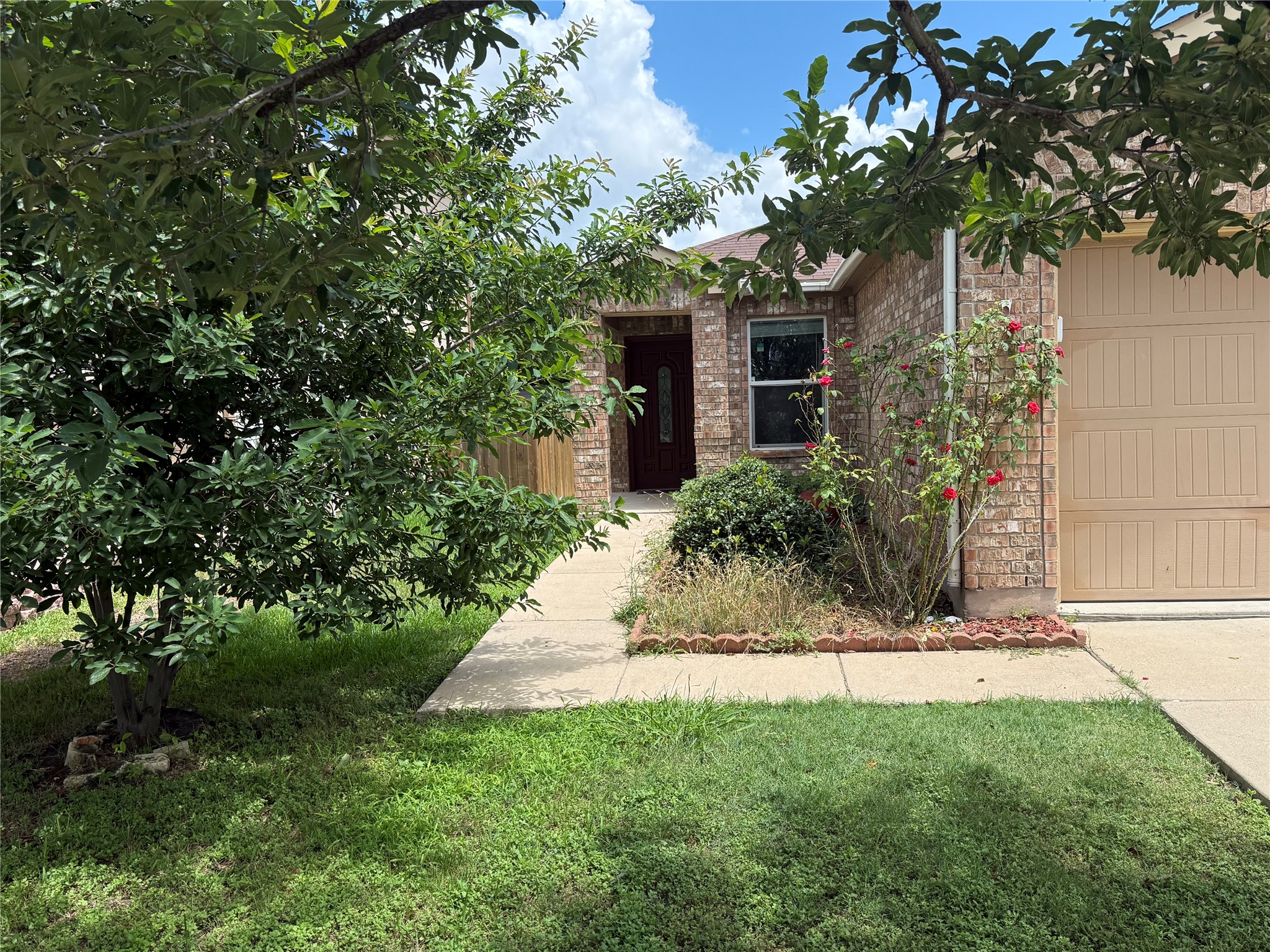 6600 Glebe Path Austin, TX 78754 - Photo 3 of 11 A classic brick exterior with a well-maintained lawn and a welcoming front entrance.