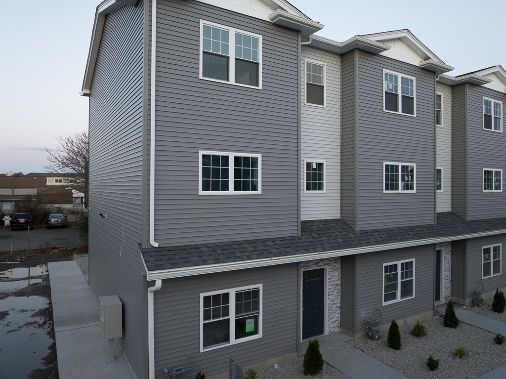 a front view of a house with parking space