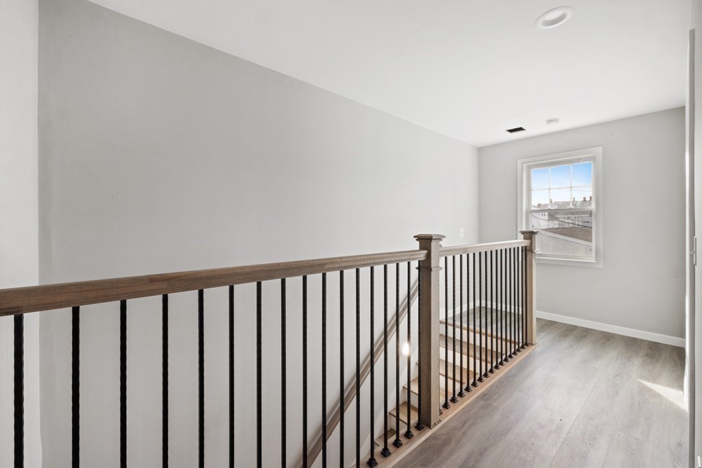550 Spring Street, Unit 2 Fall River, MA 02721 - Photo 15 of 23 a view of a hallway with wooden floor and windows