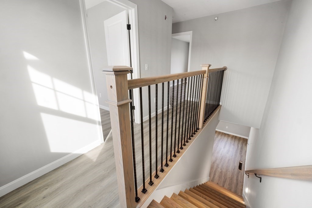 550 Spring Street, Unit 2 Fall River, MA 02721 - Photo 16 of 23 a view of a hallway with wooden floor and staircase