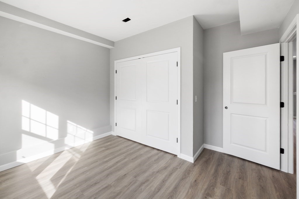 550 Spring Street, Unit 2 Fall River, MA 02721 - Photo 18 of 23 a view of empty room with wooden floor and fan
