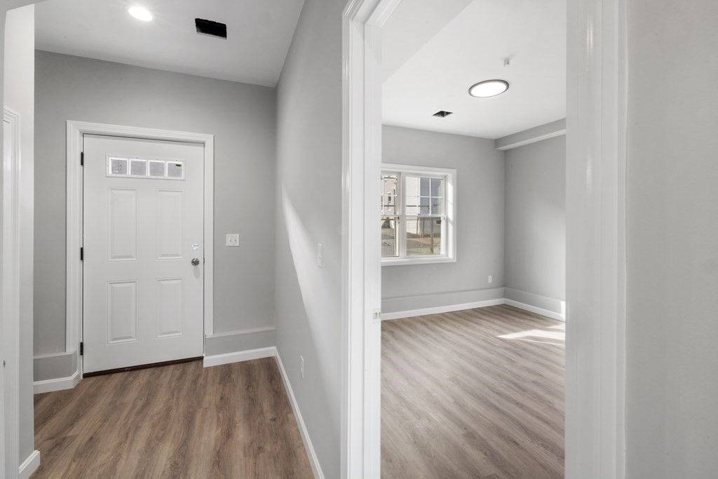 550 Spring Street, Unit 2 Fall River, MA 02721 - Photo 19 of 23 an empty room with wooden floor and windows