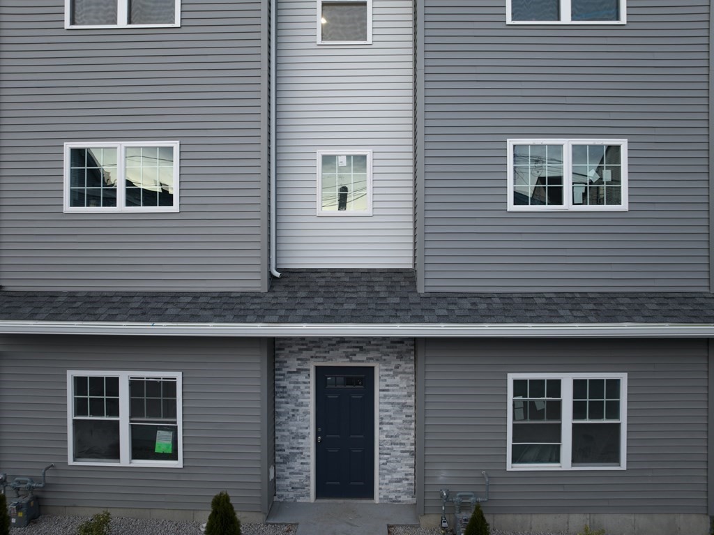 550 Spring Street, Unit 2 Fall River, MA 02721 - Photo 2 of 23 a view of a house with more windows and brick walls