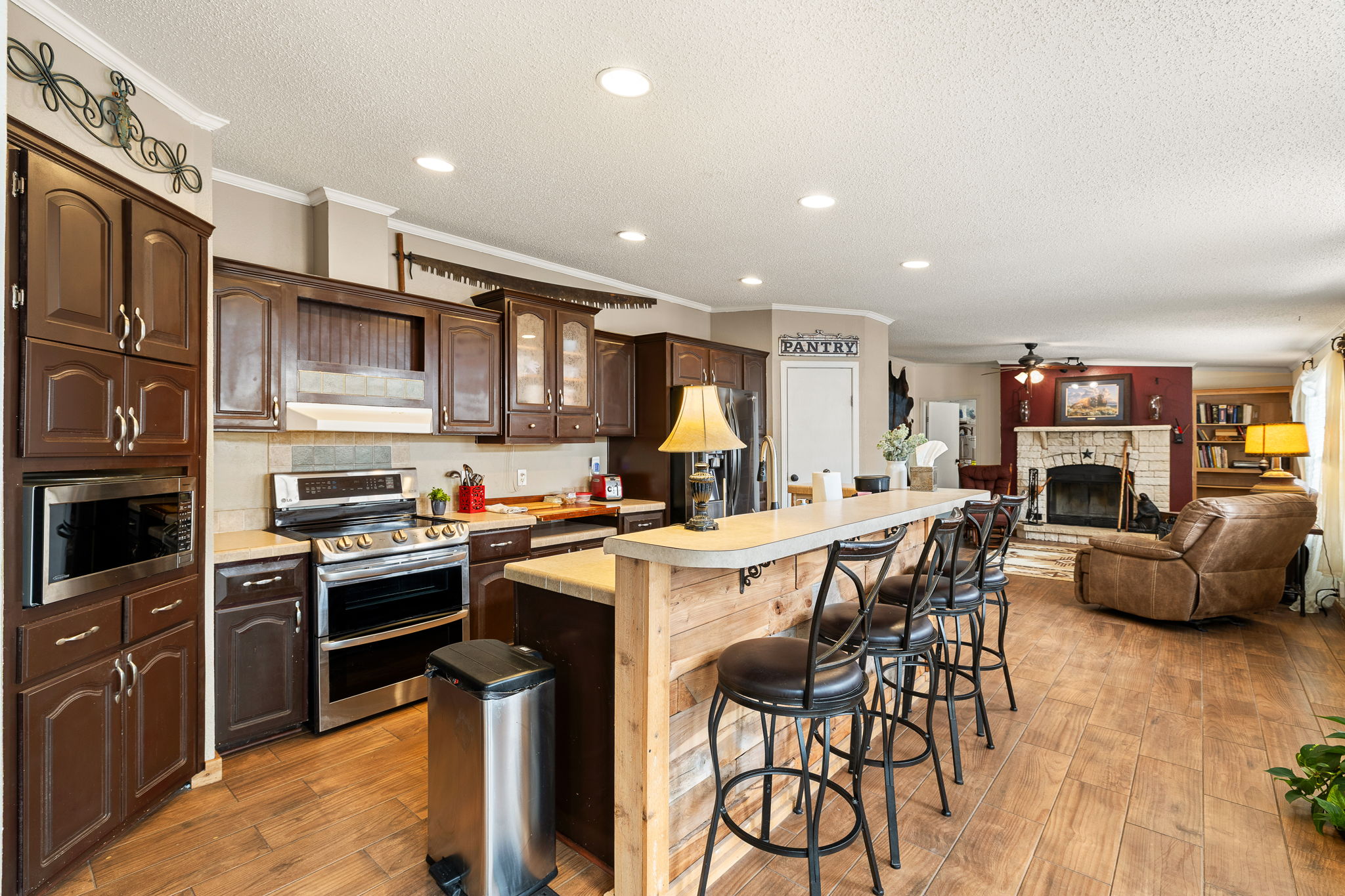 541 Hidden Oaks Drive Elgin, TX 78621 - Photo 10 of 40 Kitchen is adjacent to the den with welcoming fireplace