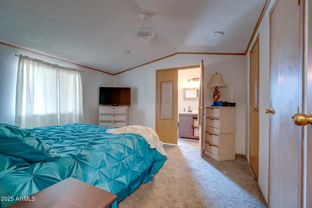 a bedroom with a bed and a flat screen tv