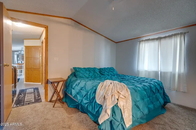 a bed sitting in a bedroom next to a window