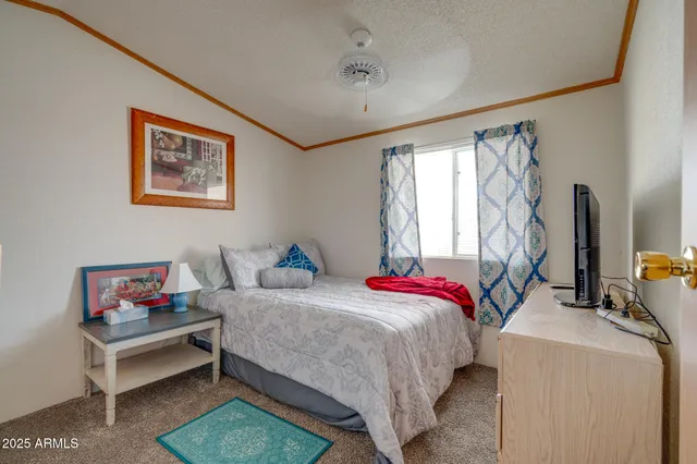 a bedroom with a bed and a desk