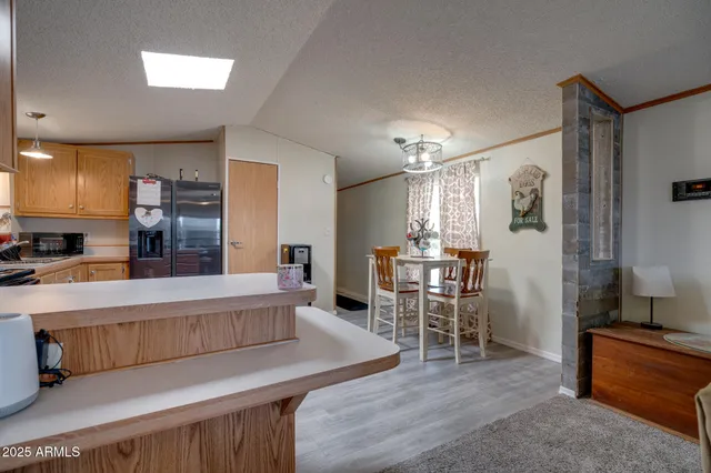 a living room with furniture a dining table and kitchen view