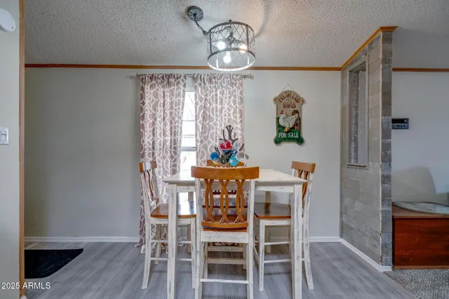 a view of a dining room with furniture wooden floor and a chandelier