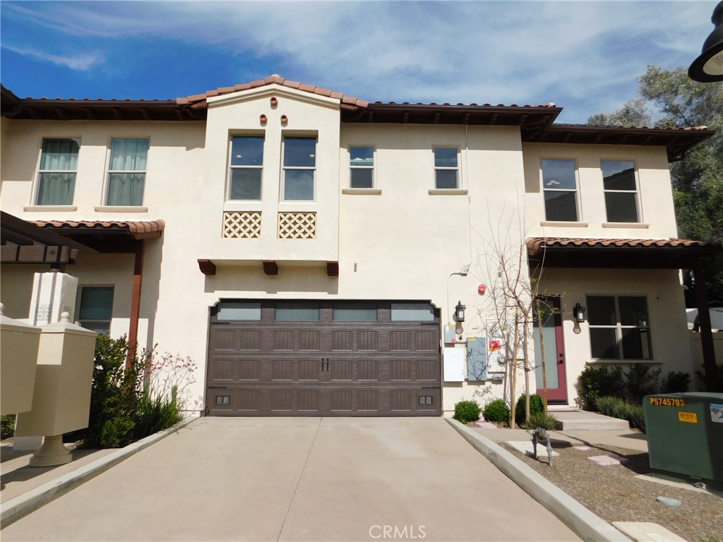a front view of a house with garage