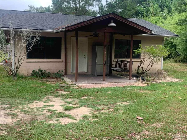a view of a house with yard and sitting area